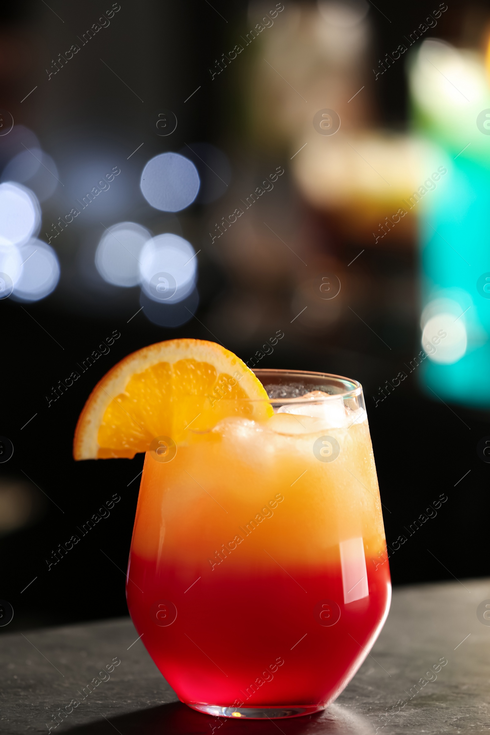 Photo of Delicious cocktail with orange on bar counter