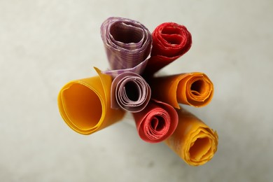 Photo of Colorful beeswax food wraps on light table, top view