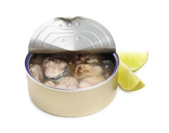 Open tin can with mackerel chunks and lime on white background