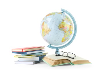Photo of Plastic model globe of Earth, books and eyeglasses on white background. Geography lesson