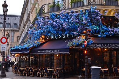 Paris, France - December 10, 2022: Exterior of Le Musset restaurant decorated with beautiful blue hydrangea flowers
