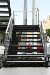 Photo of Modern stairs with metal handrailings on city street