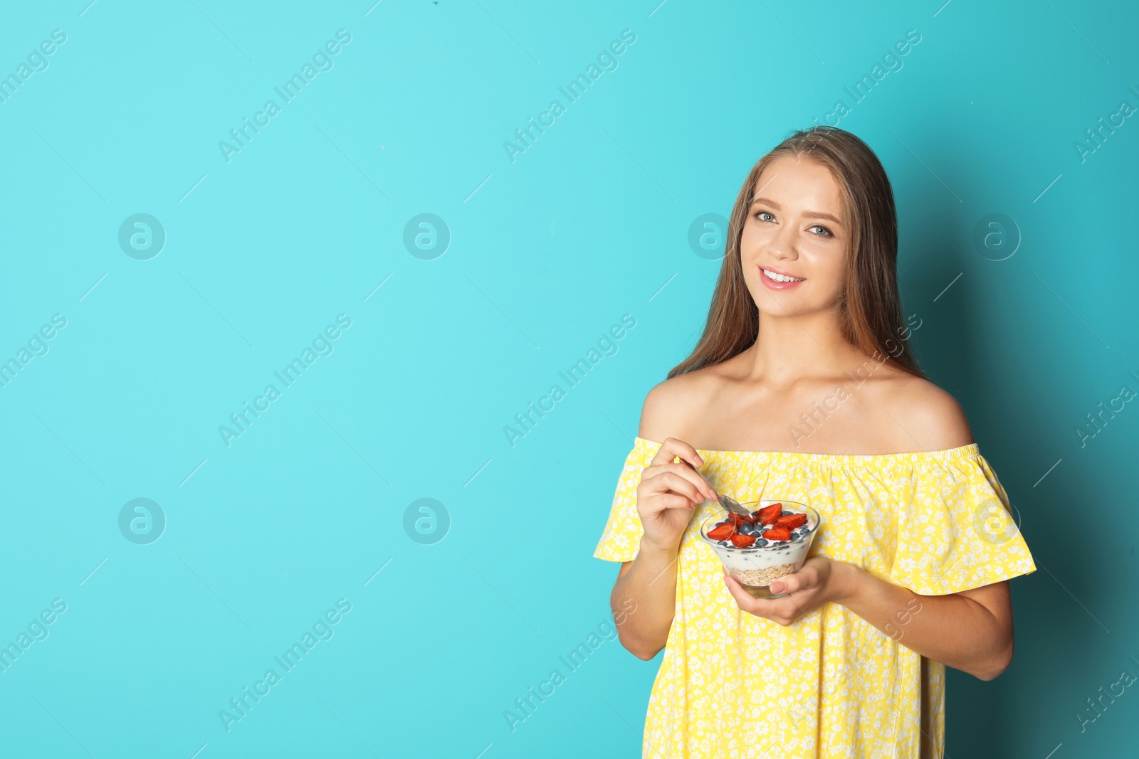 Photo of Young woman with tasty dessert on color background. Healthy diet