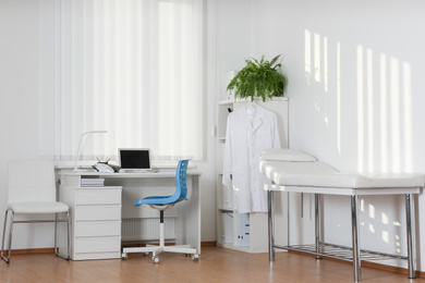 Photo of Interior of modern medical office with doctor's workplace