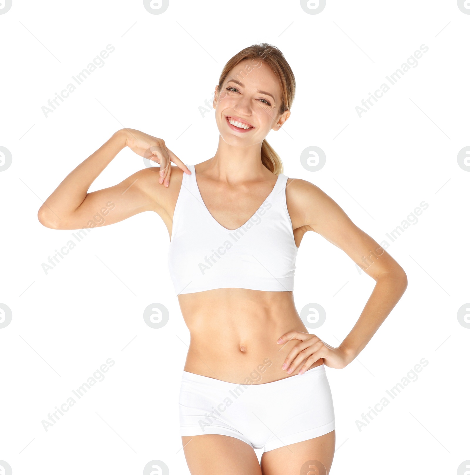 Photo of Happy young woman in underwear satisfied with her diet results, isolated on white