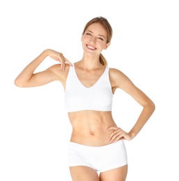 Happy young woman in underwear satisfied with her diet results, isolated on white