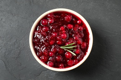 Cranberry sauce with rosemary on dark grey table, top view