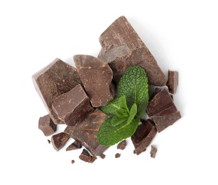 Tasty dark chocolate pieces with mint on white background, top view