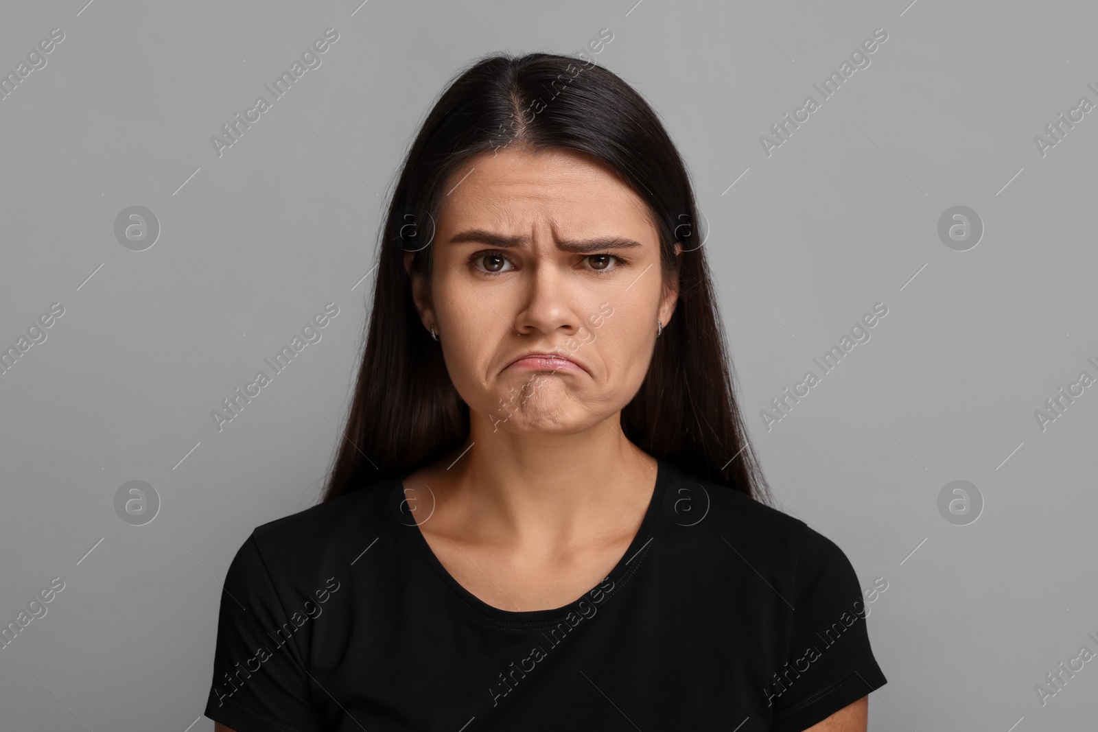 Photo of Personality concept. Emotional woman on grey background