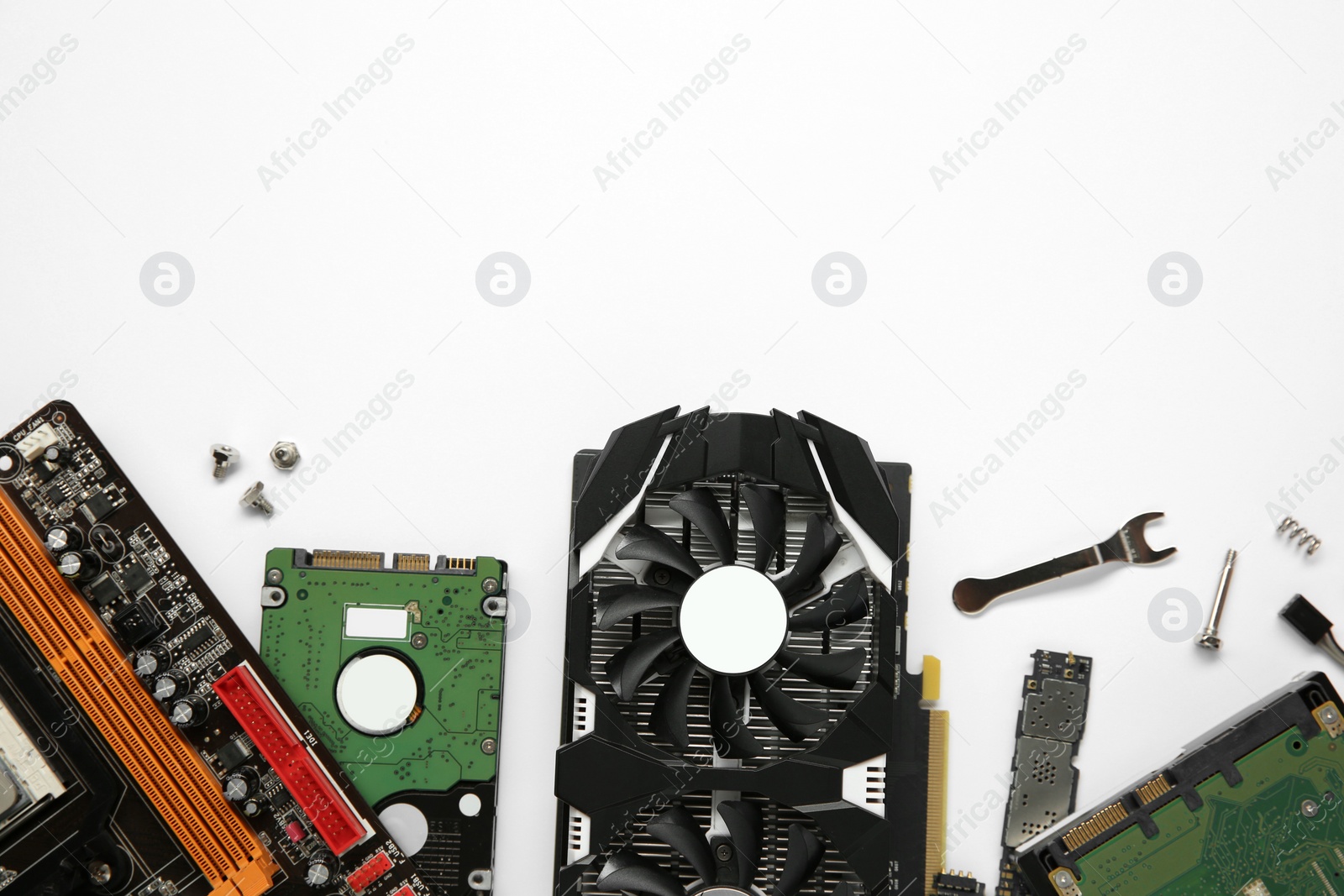 Photo of Graphics card and other computer hardware on white background, flat lay. Space for text