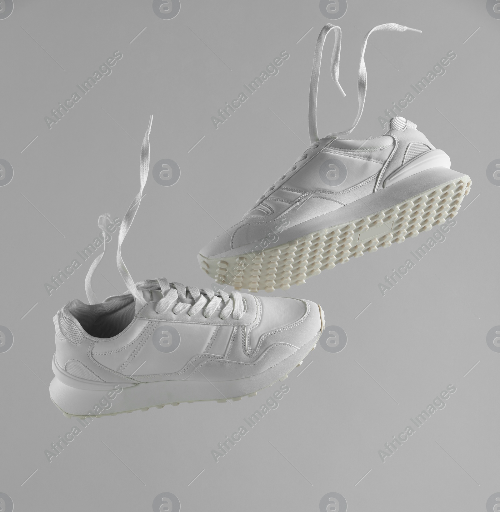 Photo of Pair of stylish white sneakers on light grey background. Space for text