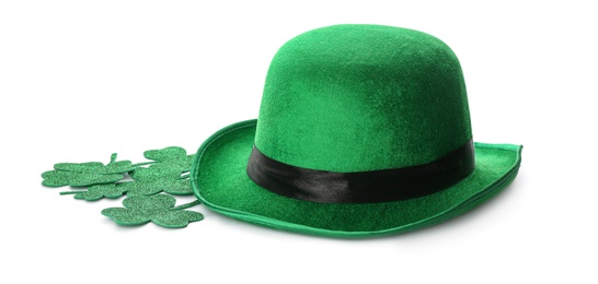 Photo of Leprechaun's hat and decorative clover leaves on white background. St. Patrick's day celebration