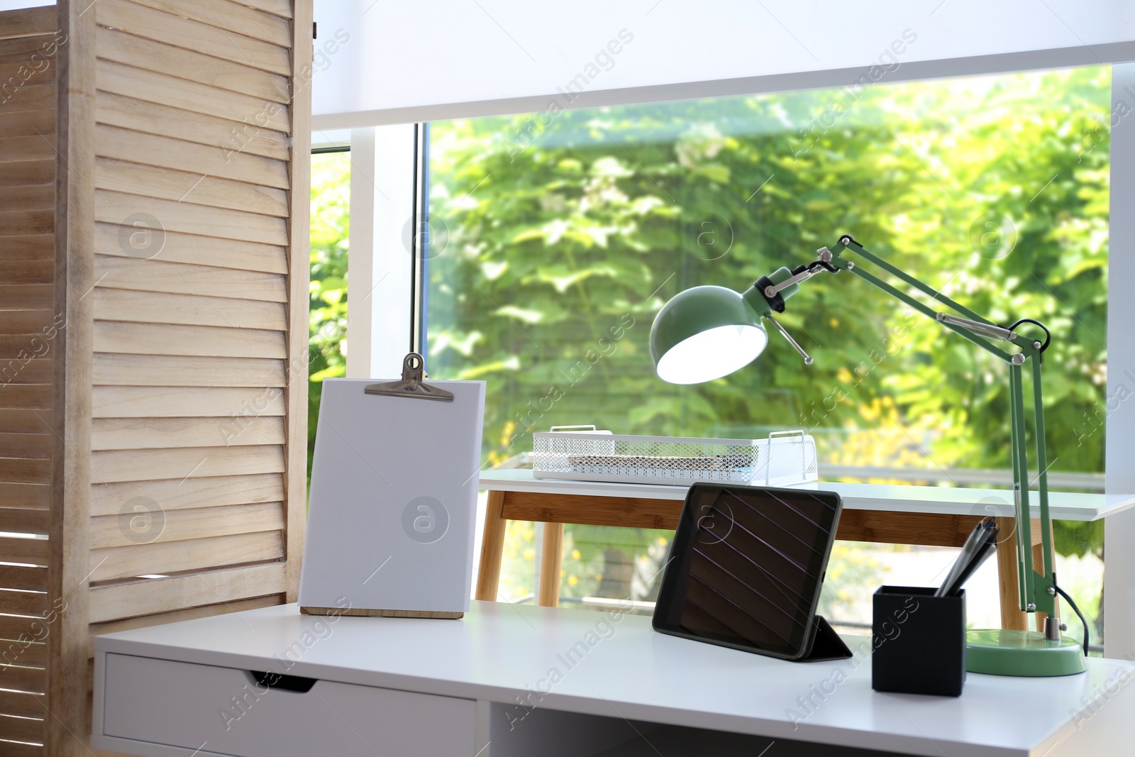 Photo of Stylish room interior with comfortable workplace near window