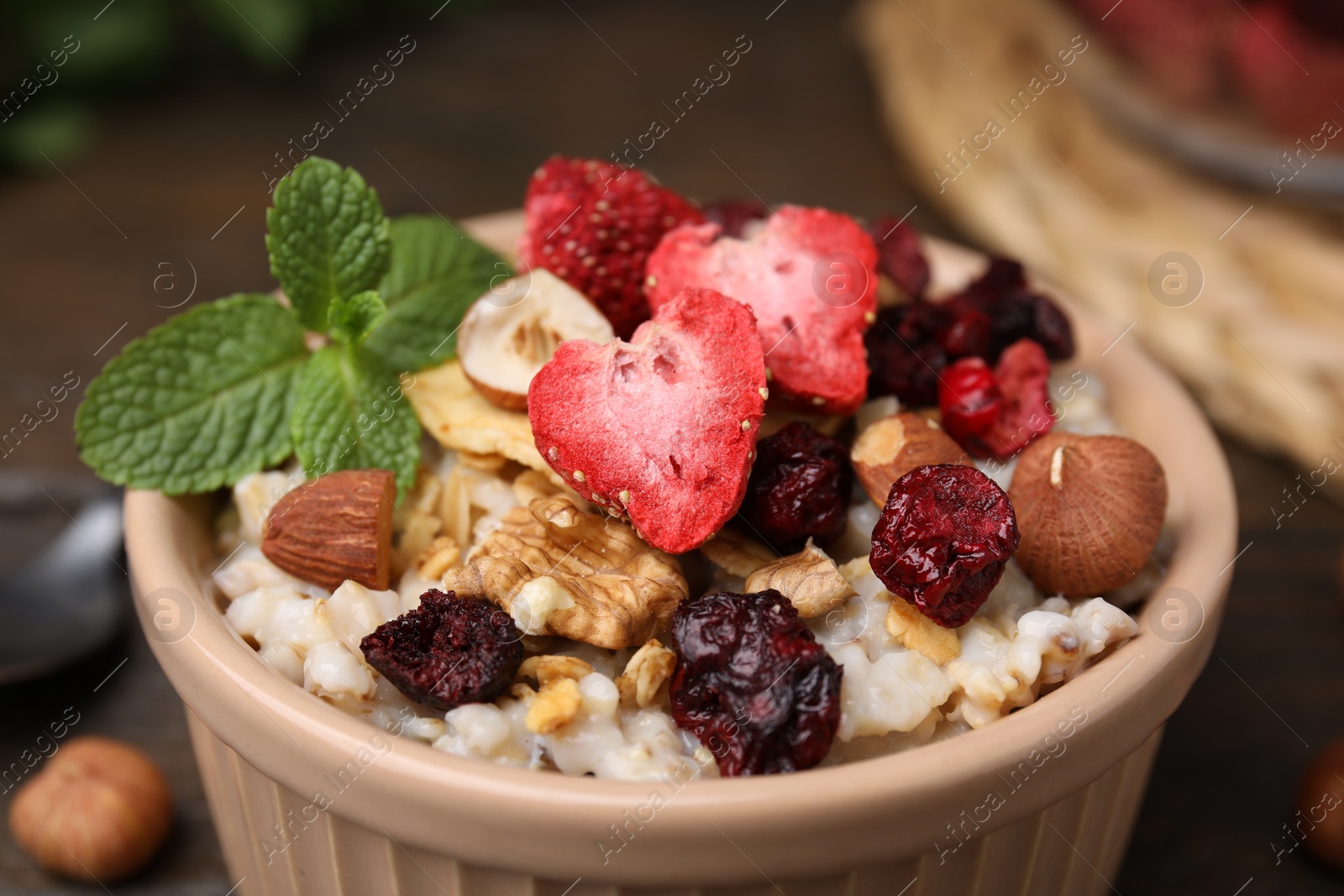 Photo of Oatmeal with freeze dried fruits, nuts and mint, closeup