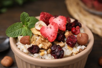 Photo of Oatmeal with freeze dried fruits, nuts and mint, closeup