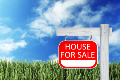 Image of Red real estate sign with inscription HOUSE FOR SALE outdoors on sunny day, space for text 