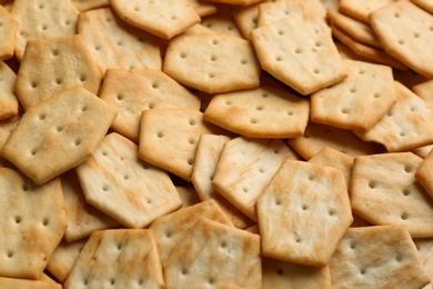 Photo of Many delicious crackers as background, closeup view