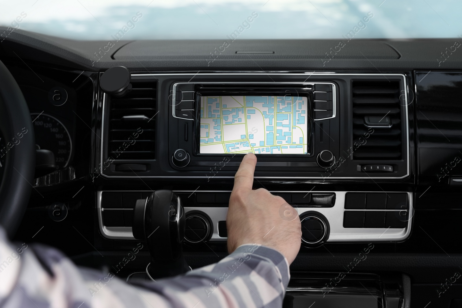 Image of Man using navigation system while driving car, closeup