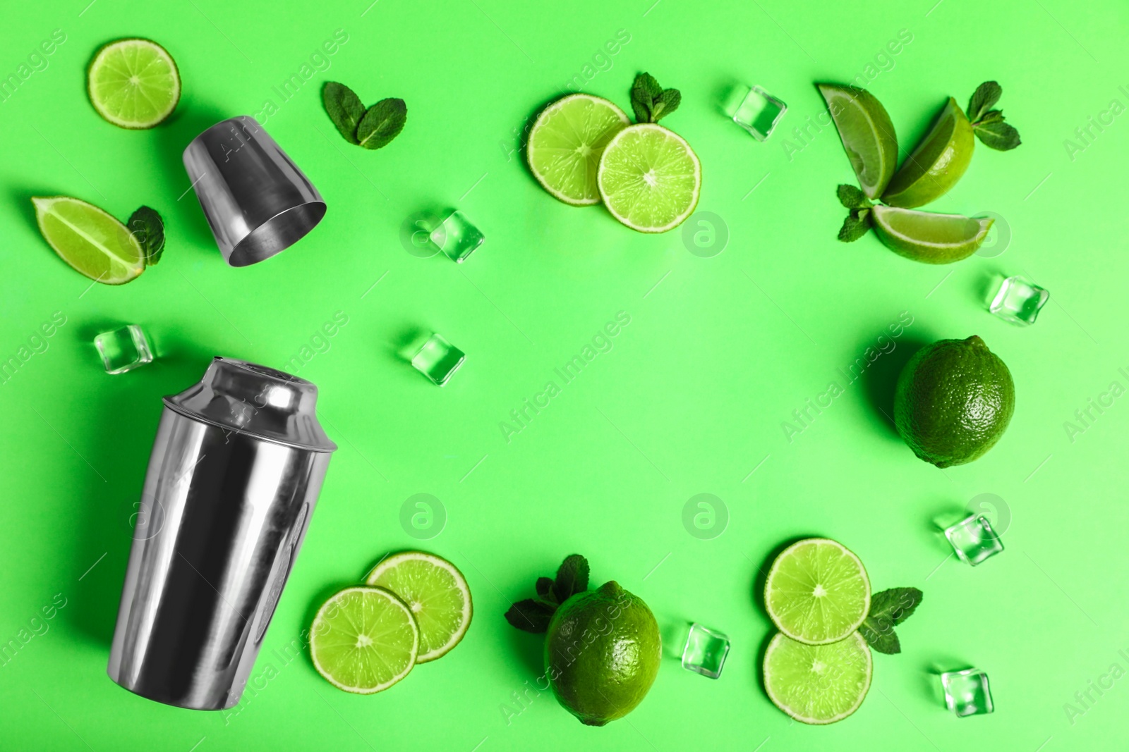 Photo of Flat lay composition with fresh juicy limes on light green background, space for text