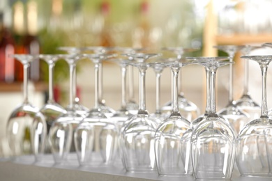 Photo of Empty glasses on table against blurred background