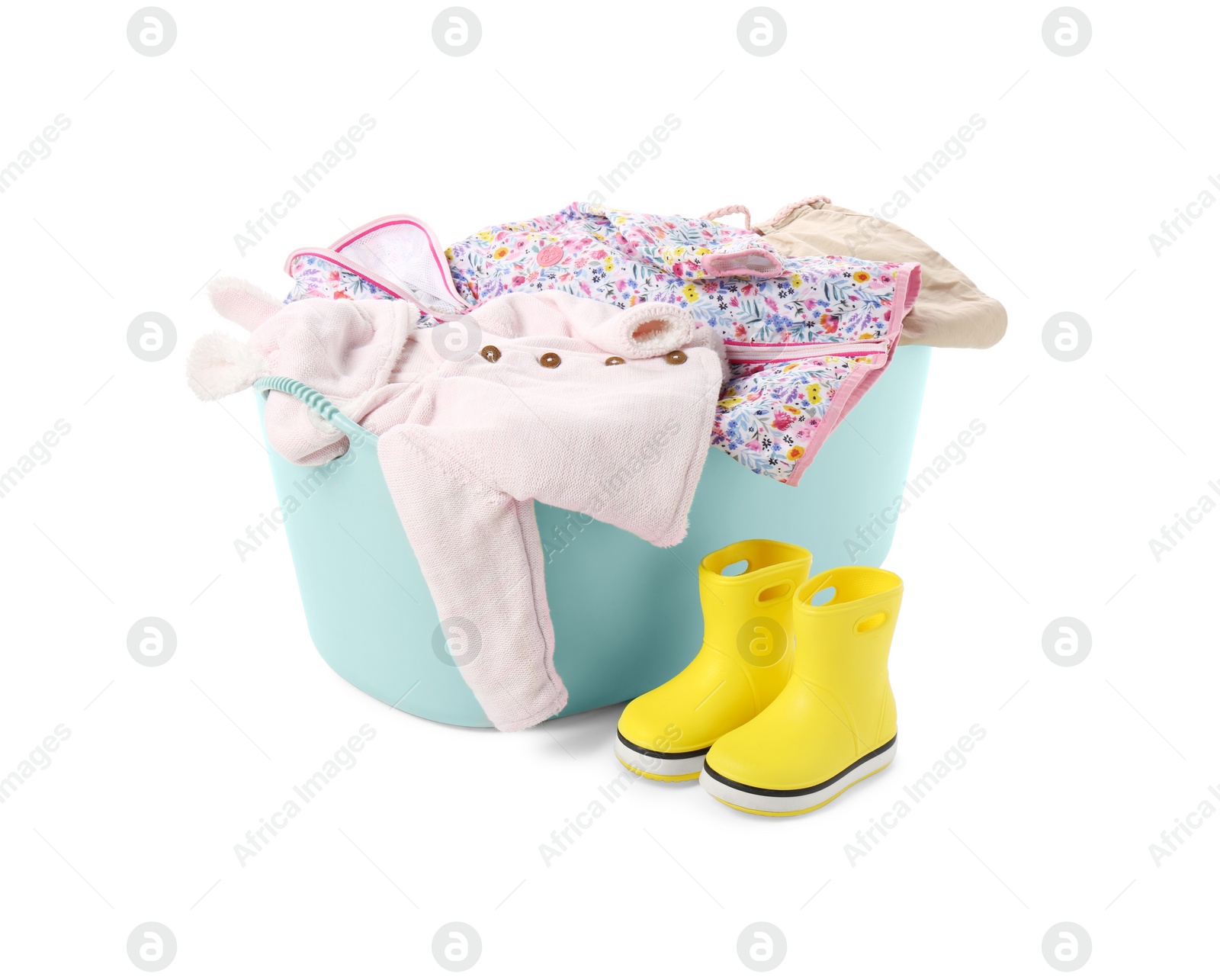 Photo of Laundry basket with baby clothes and rubber boots isolated on white