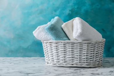 Basket with clean towels on table