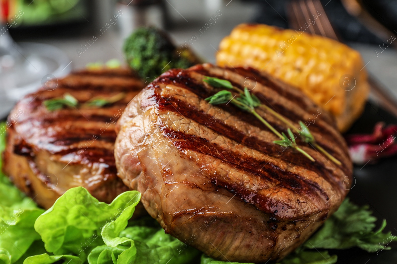 Photo of Closeup view of delicious grilled beef medallions on table