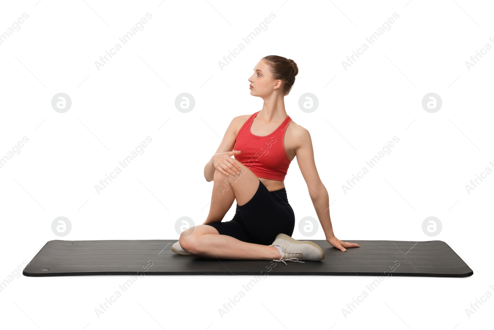 Photo of Yoga workout. Young woman stretching on white background