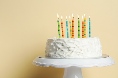 Photo of Birthday cake with candles against color background