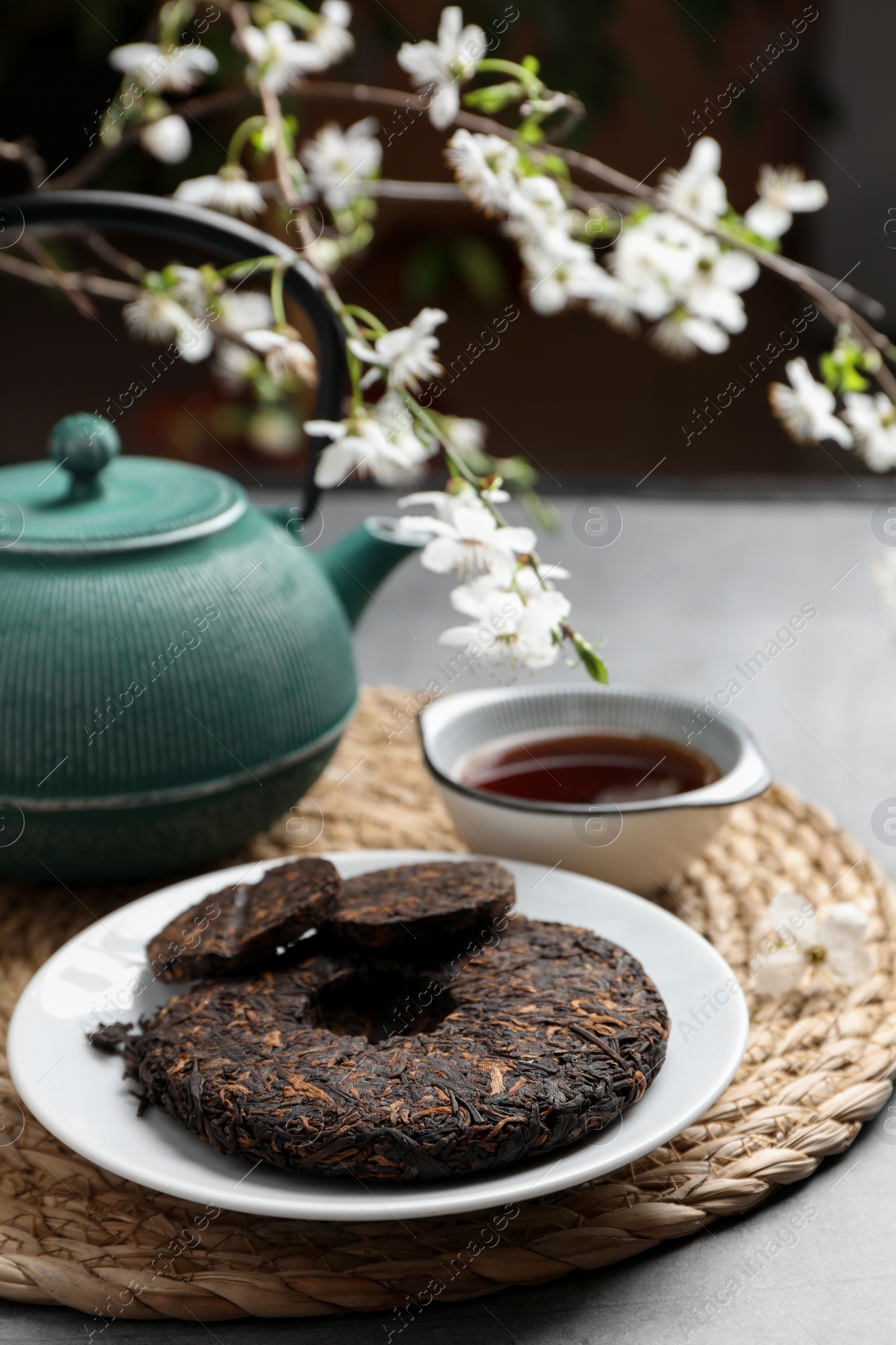 Photo of Composition with aromatic pu-erh tea on grey table