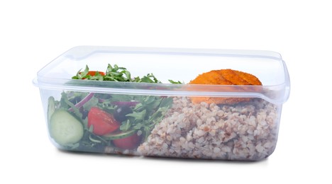 Photo of Tasty buckwheat with cutlet and salad in plastic container isolated on white