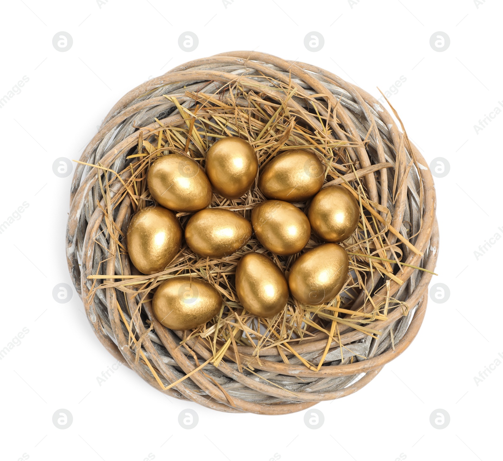 Photo of Shiny golden eggs in nest on white background, top view