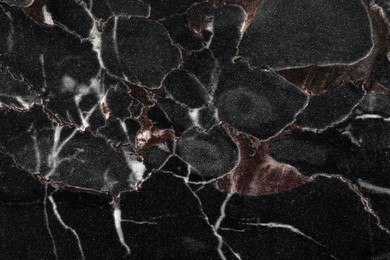 Texture of black marble stone surface as background, closeup