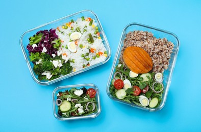 Photo of Set of glass containers with fresh food on light blue background, flat lay