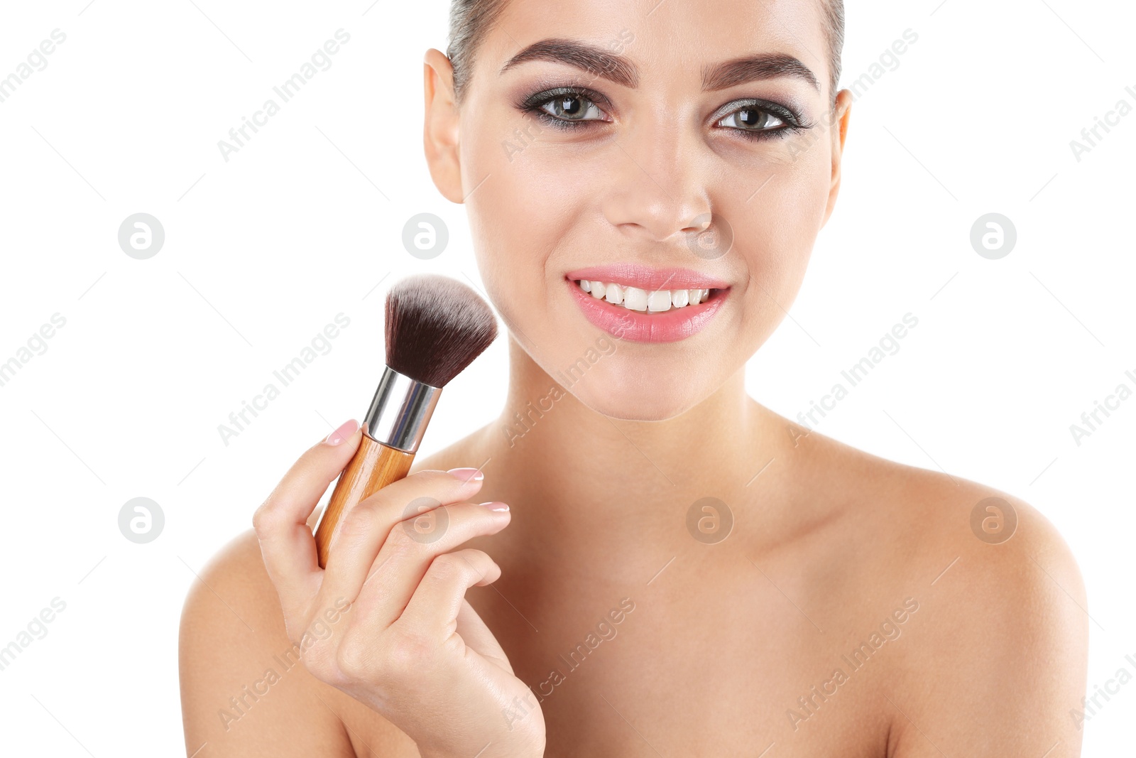 Photo of Portrait of beautiful woman applying stylish makeup with brush on white background