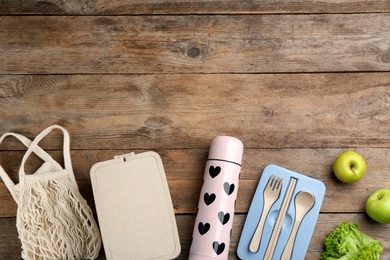 Photo of Flat lay composition with thermos on wooden table. Space for text