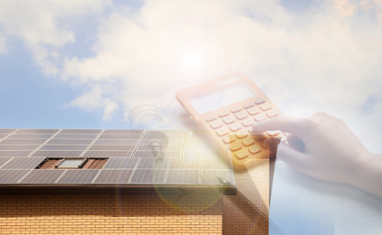 Image of Double exposure of house with installed solar panels and woman using calculator. Renewable energy and money saving