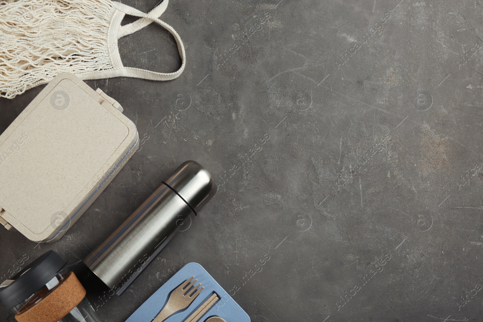 Photo of Flat lay composition with thermos on grey table. Space for text