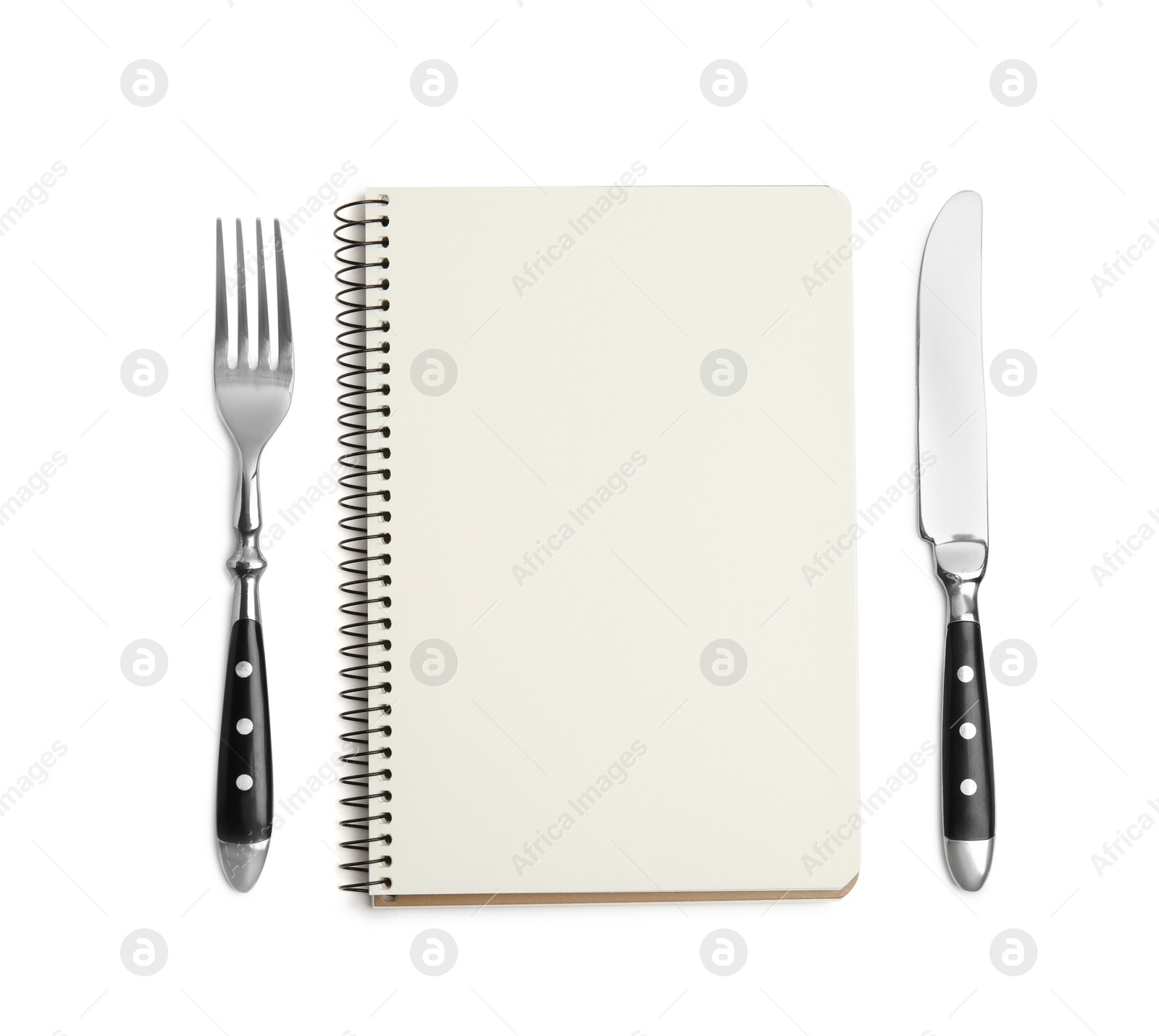 Photo of Blank recipe book and cutlery on white background, top view. Space for text