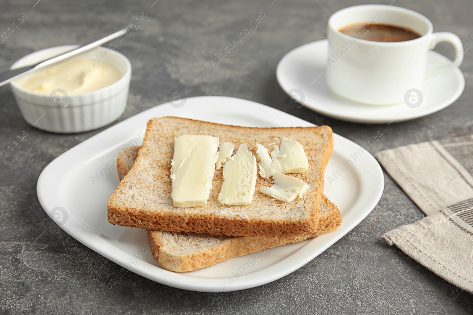 Photo of Bread with butter served for breakfast on grey table