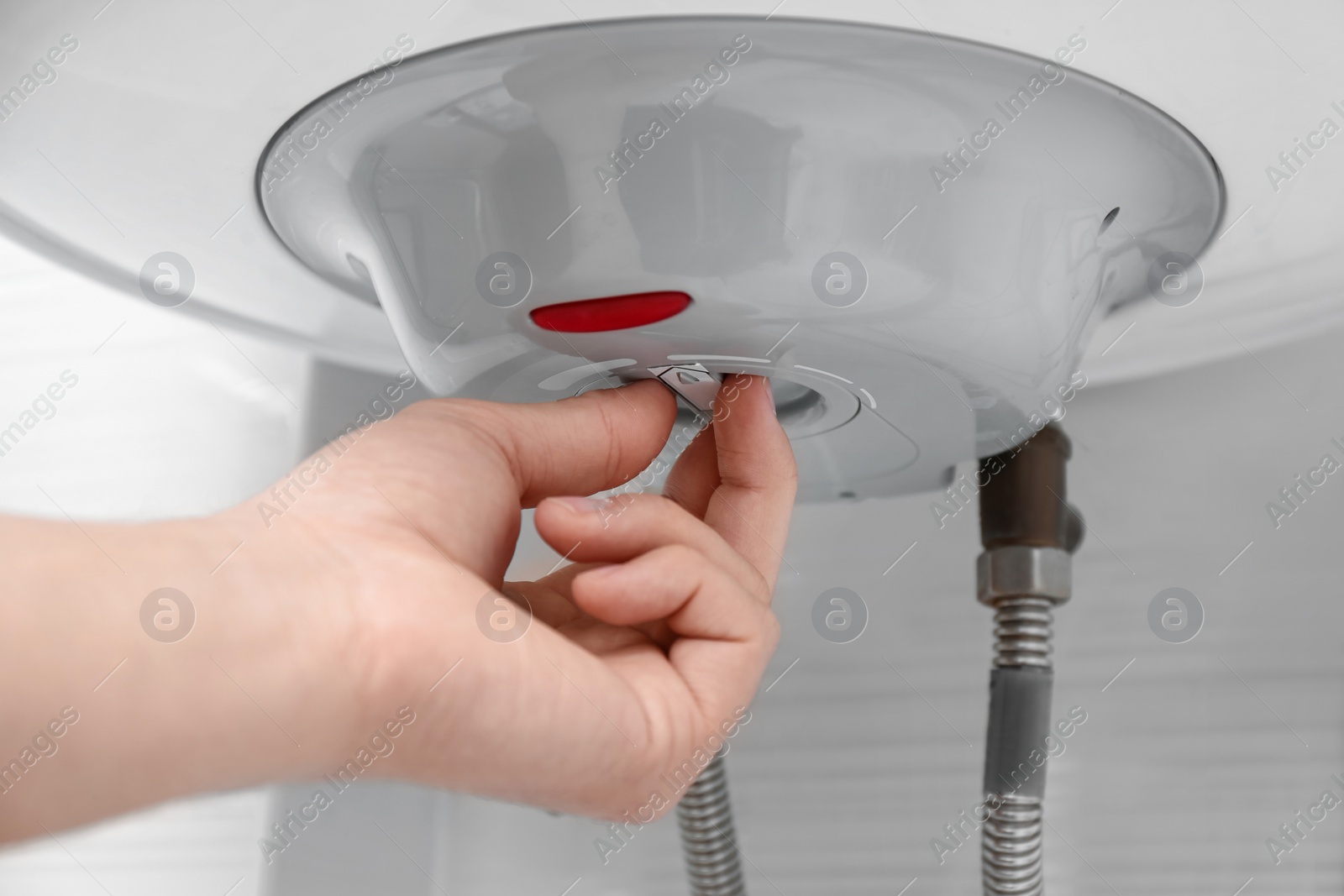 Photo of Woman adjusting maximum energy efficiency indicator indoors, closeup. Boiler installation