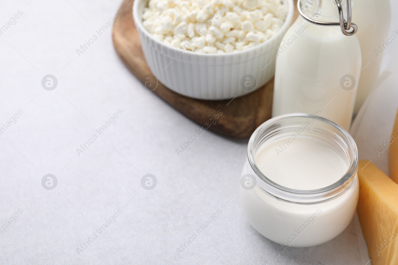 Photo of Different fresh dairy products on light table. Space for text