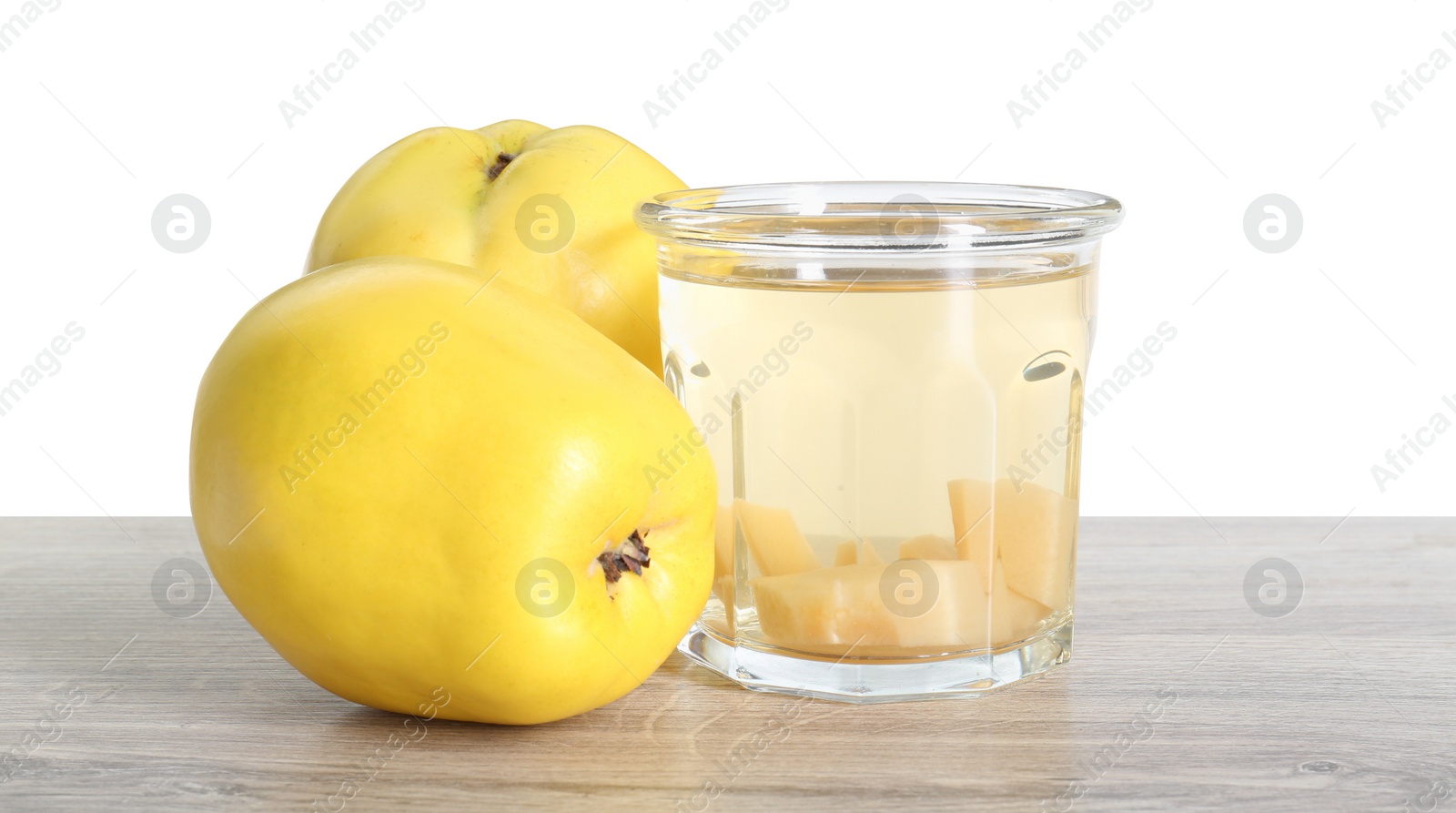 Photo of Delicious quince drink and fresh fruits on wooden table against white background