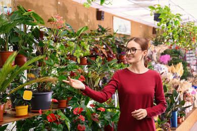 Photo of Female business owner showing flowers in her shop