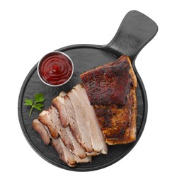Photo of Pieces of tasty baked pork belly, sauce and parsley isolated on white, top view