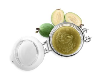 Feijoa jam in glass jar and fresh fruits on white background, top view