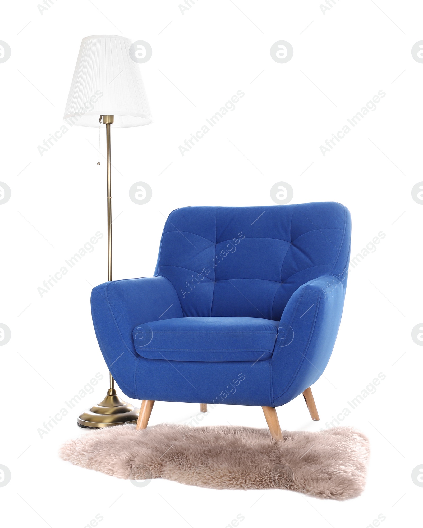 Photo of Comfortable armchair with floor lamp and faux fur rug isolated on white