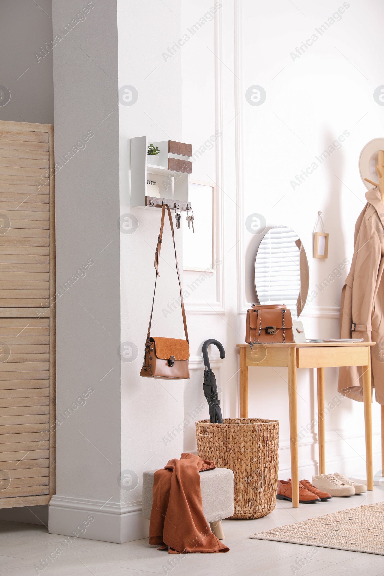 Photo of Modern hallway interior with stylish dressing table and key holder