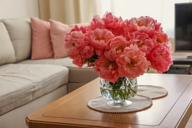 Photo of Beautiful pink peonies in vase on table at home, space for text. Interior design