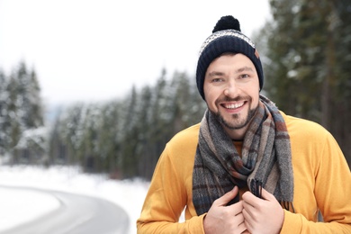 Photo of Man in warm clothes outdoors, space for text. Winter vacation